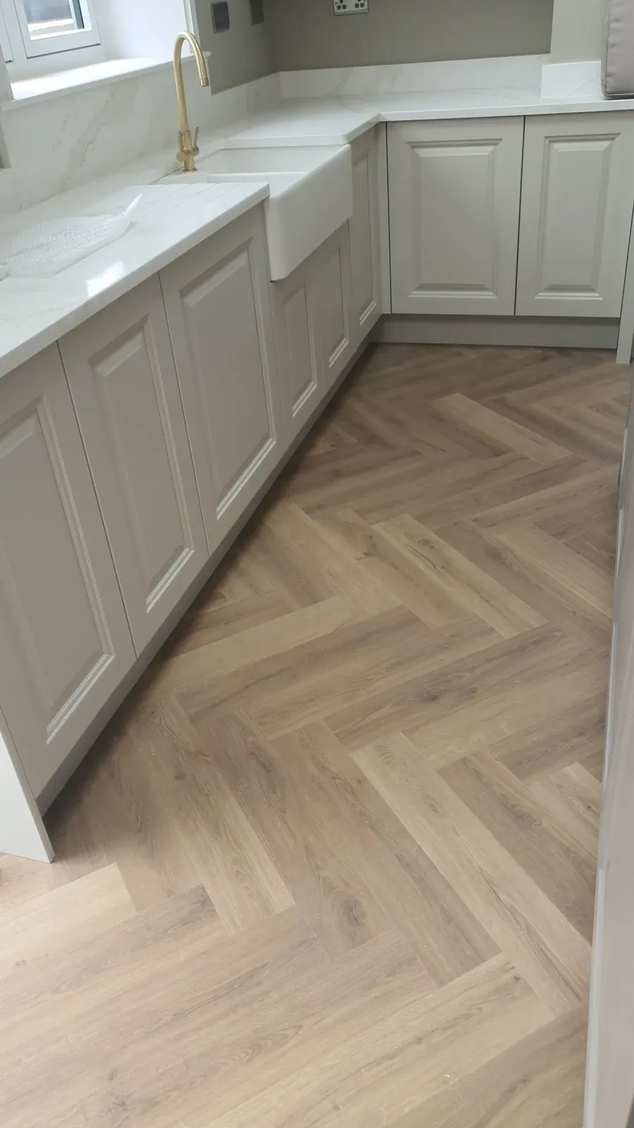 Kitchen cabinetry and herringbone flooring