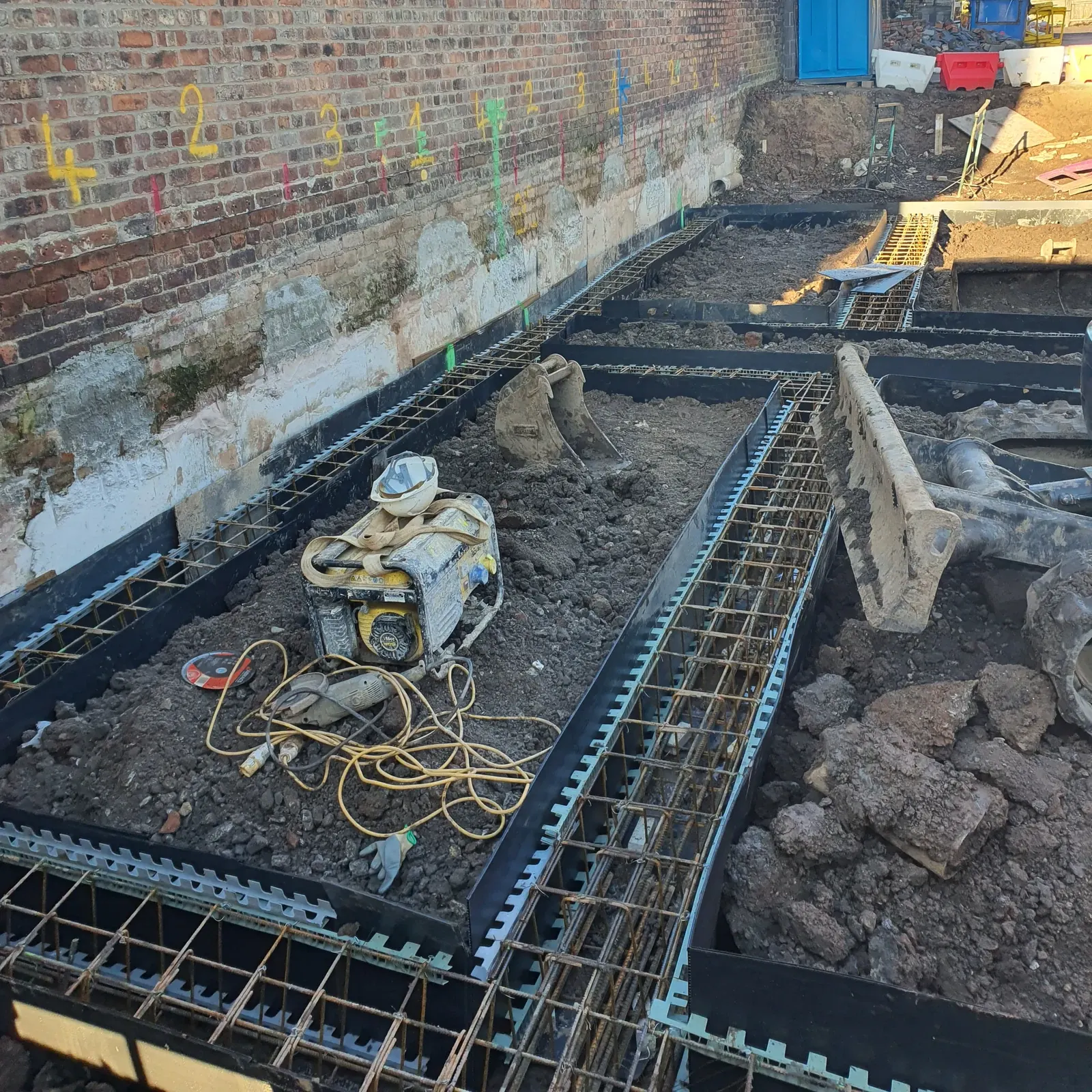 Foundation cages set out beside the boundary wall