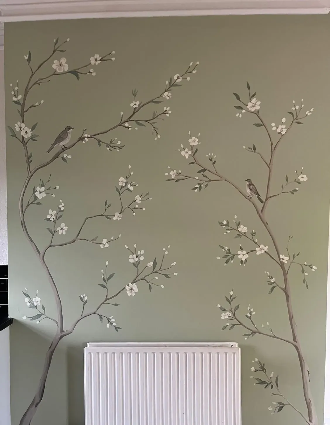 Birds and blossom painted by hand