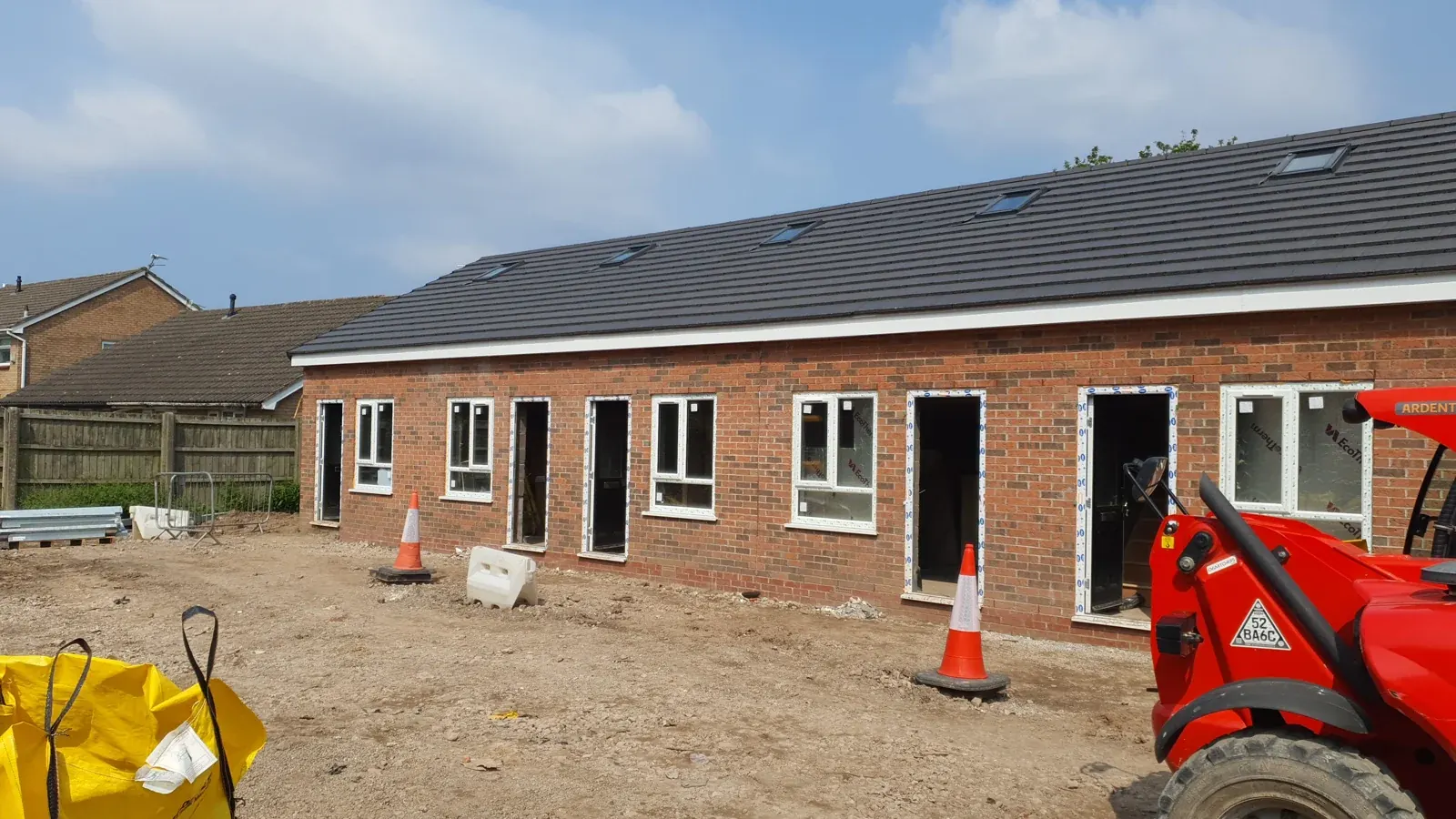 The new block with telehandler on site